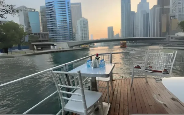 Scenic night views of Dubai Marina, Bluewaters Island, and Ain Dubai from a traditional dhow cruise.