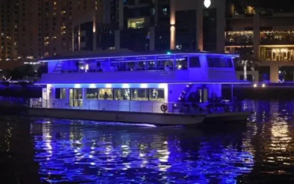 Night view of Dubai Marina dhow cruise with buffet dinner and live entertainment onboard
