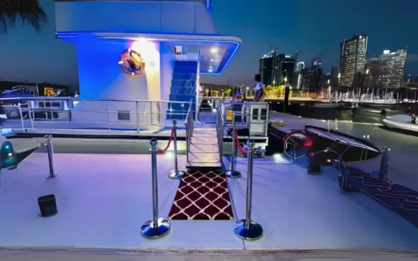 Guests enjoying an international buffet dinner on a dhow cruise in Dubai Marina with panoramic waterfront views