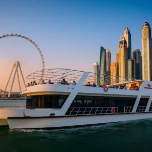 Luxury exclusive yacht dinner cruise yacht sailing through Dubai Marina at sunset and night with city skyline in the background